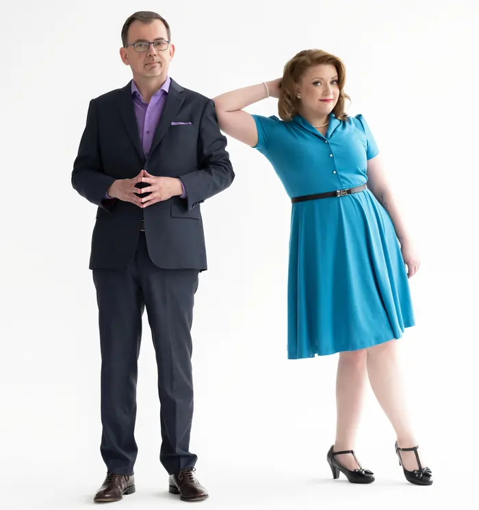 Jason Reid in suit and Kristin Light standing irreverently next to him