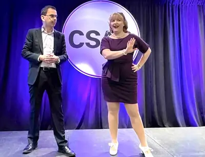 Kristin and Jaosn on stage talking about leadership inclusion programs